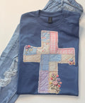Blue t-shirt with a colorful cross design on a white background