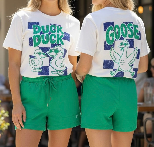 Two people wearing matching outfits with 'Duck Duck Goose' graphic t-shirts.