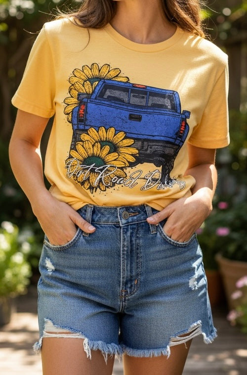 Person wearing a yellow t-shirt with a graphic of a blue truck and sunflowers, paired with denim shorts.