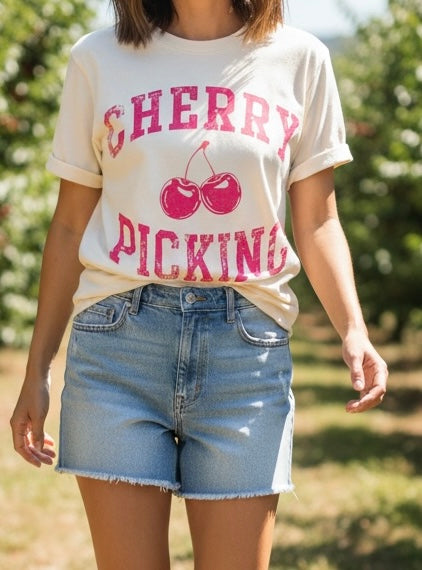 Person wearing a 'Cherry Picking' t-shirt in an outdoor setting