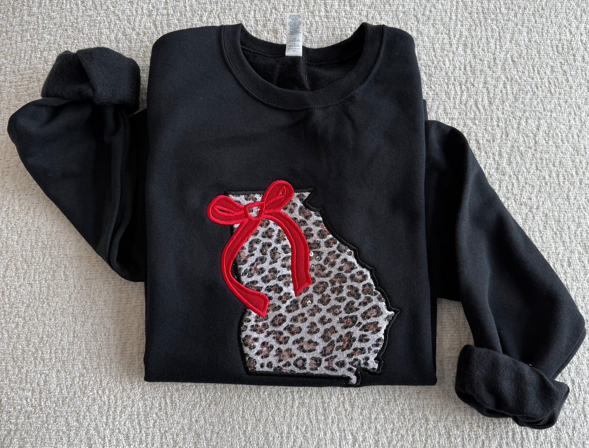 Georgia Black Sweatshirt with Leopard Sequin Appliqué and red bow appliqué. &nbsp;